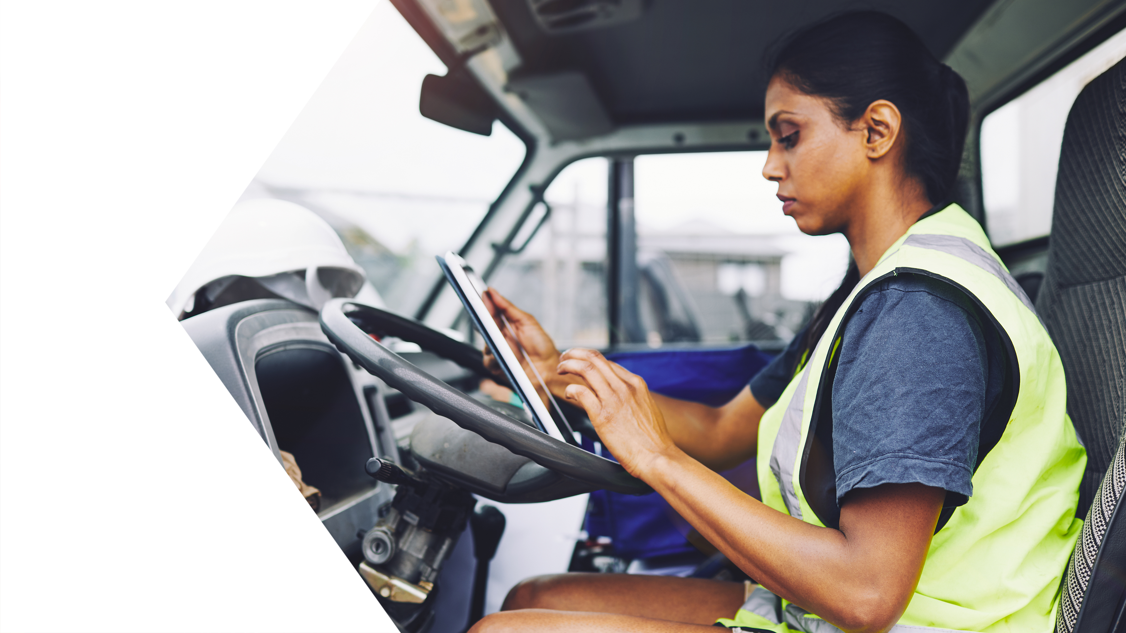 woman holding tablet in work vehicle