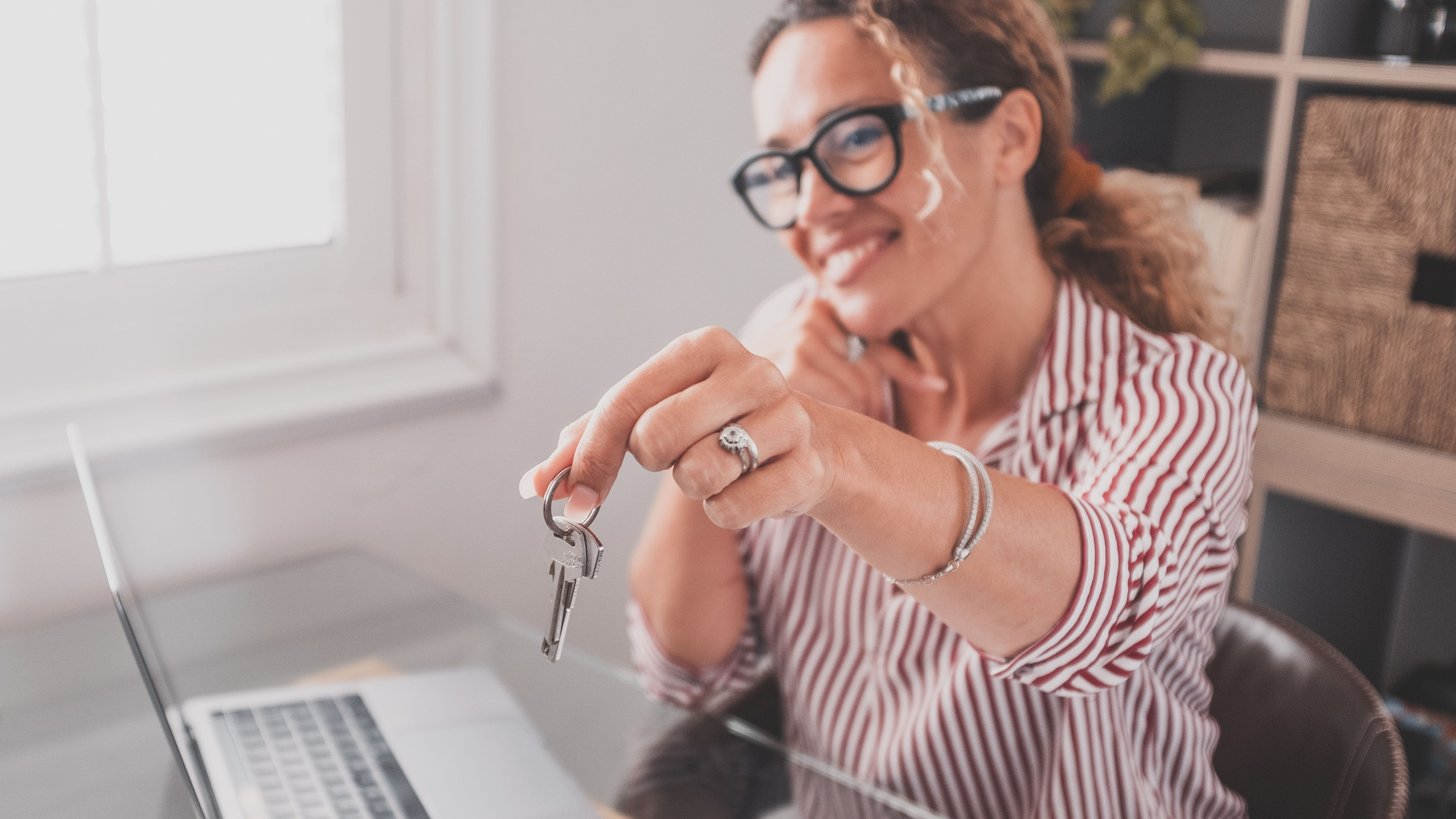 Woman handing over a house key