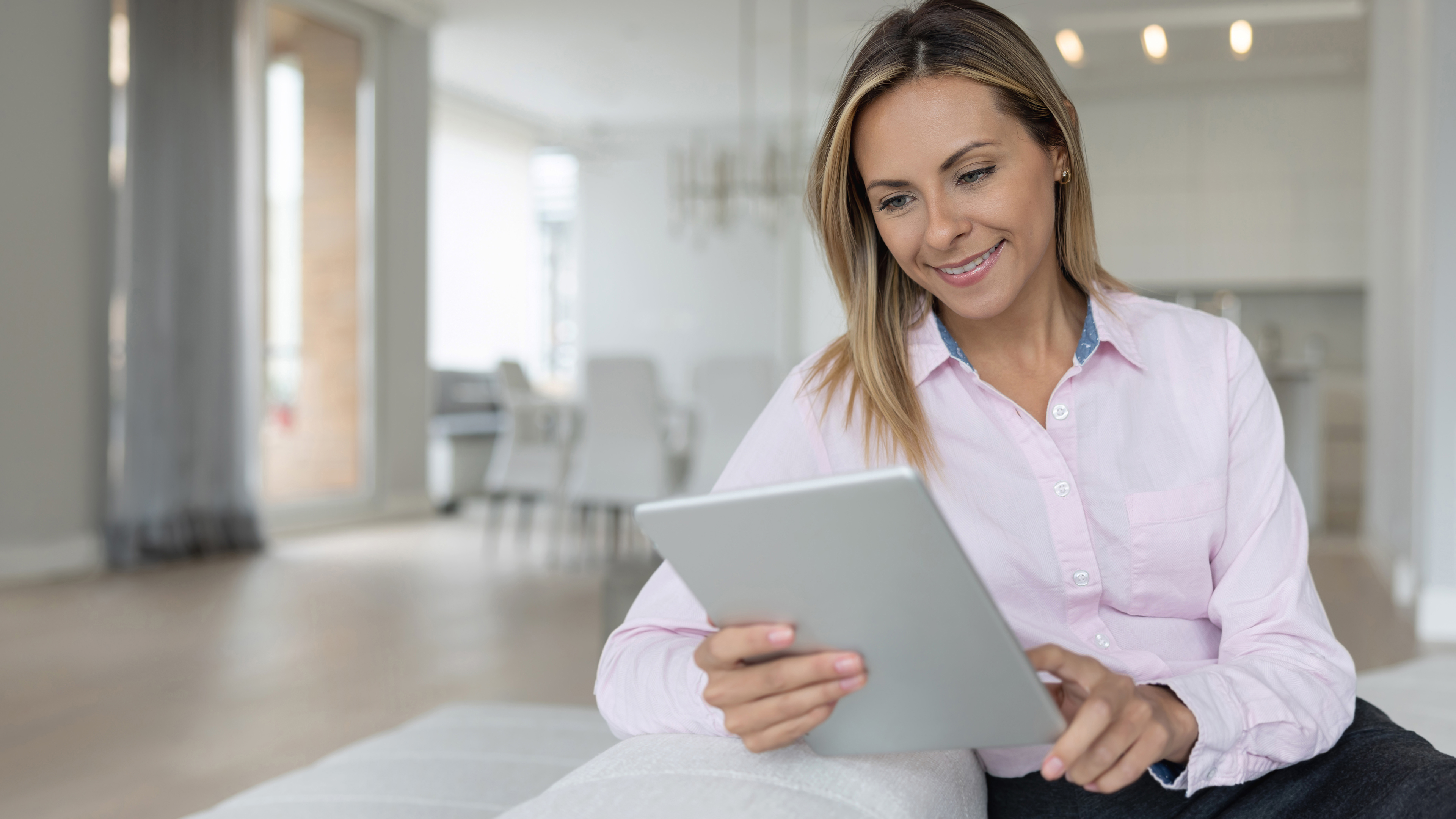 Realtor using a tablet on the couch