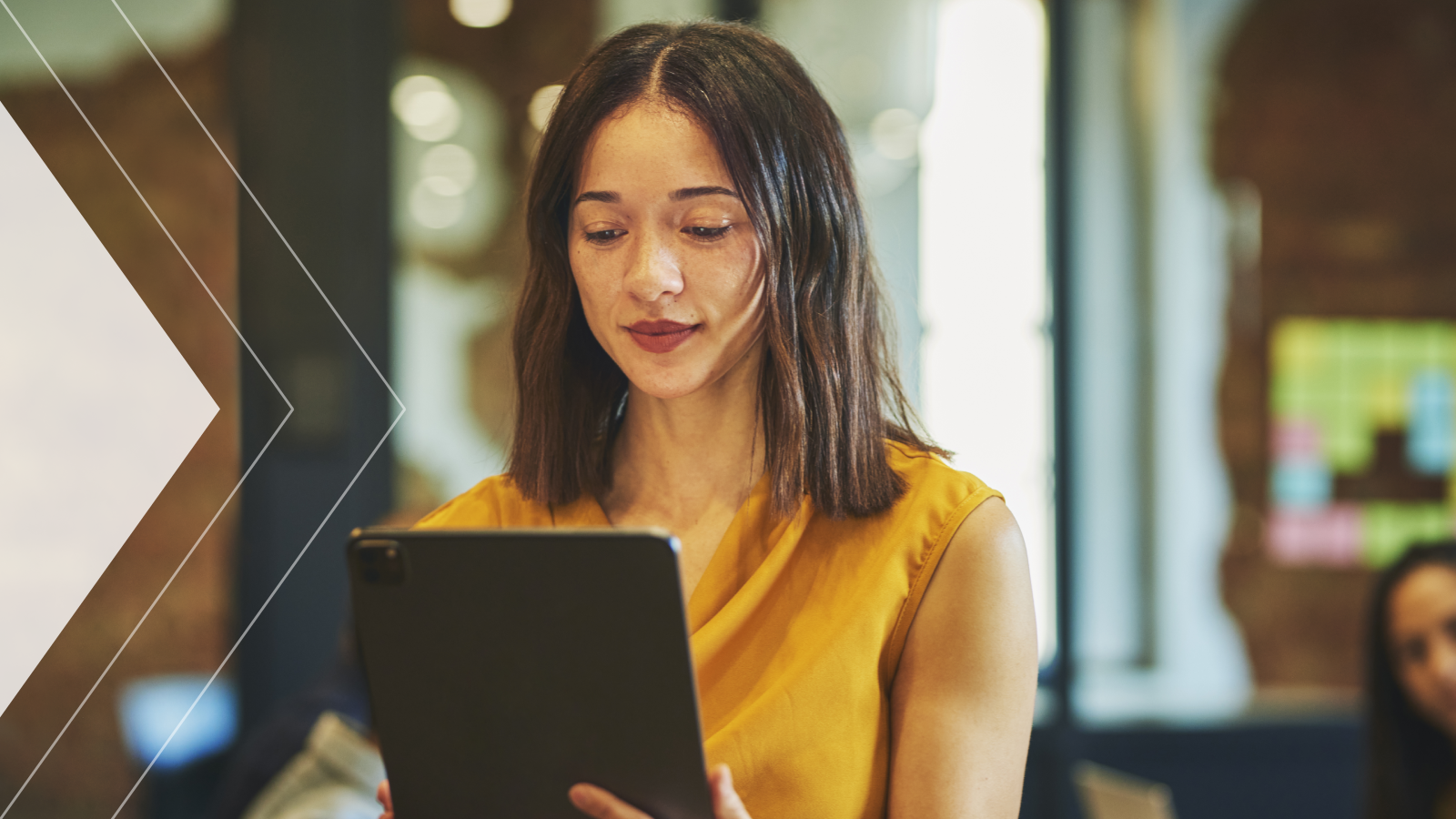 A woman holds a tablet